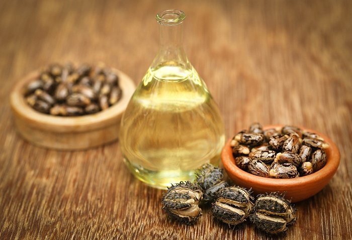 Castor beans and oil in a glass jar (Source: Bigstockphoto)