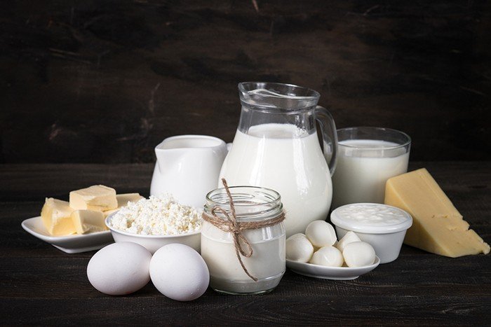 Selection of Dairy products on the wooden table. Cottage cheese yogurt Sour cream milk egg cheese and butter. Country style. (Source: Bigstockphoto)
